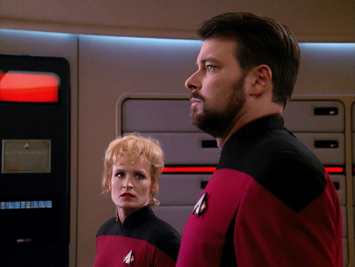 Shelby looks over to Will Riker who gravely looks at the viewscreen ahead of him in 'The Best of Both Worlds, Part I'