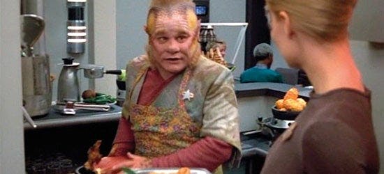 Neelix preps food as Seven of Nine watches on Star Trek: Voyager
