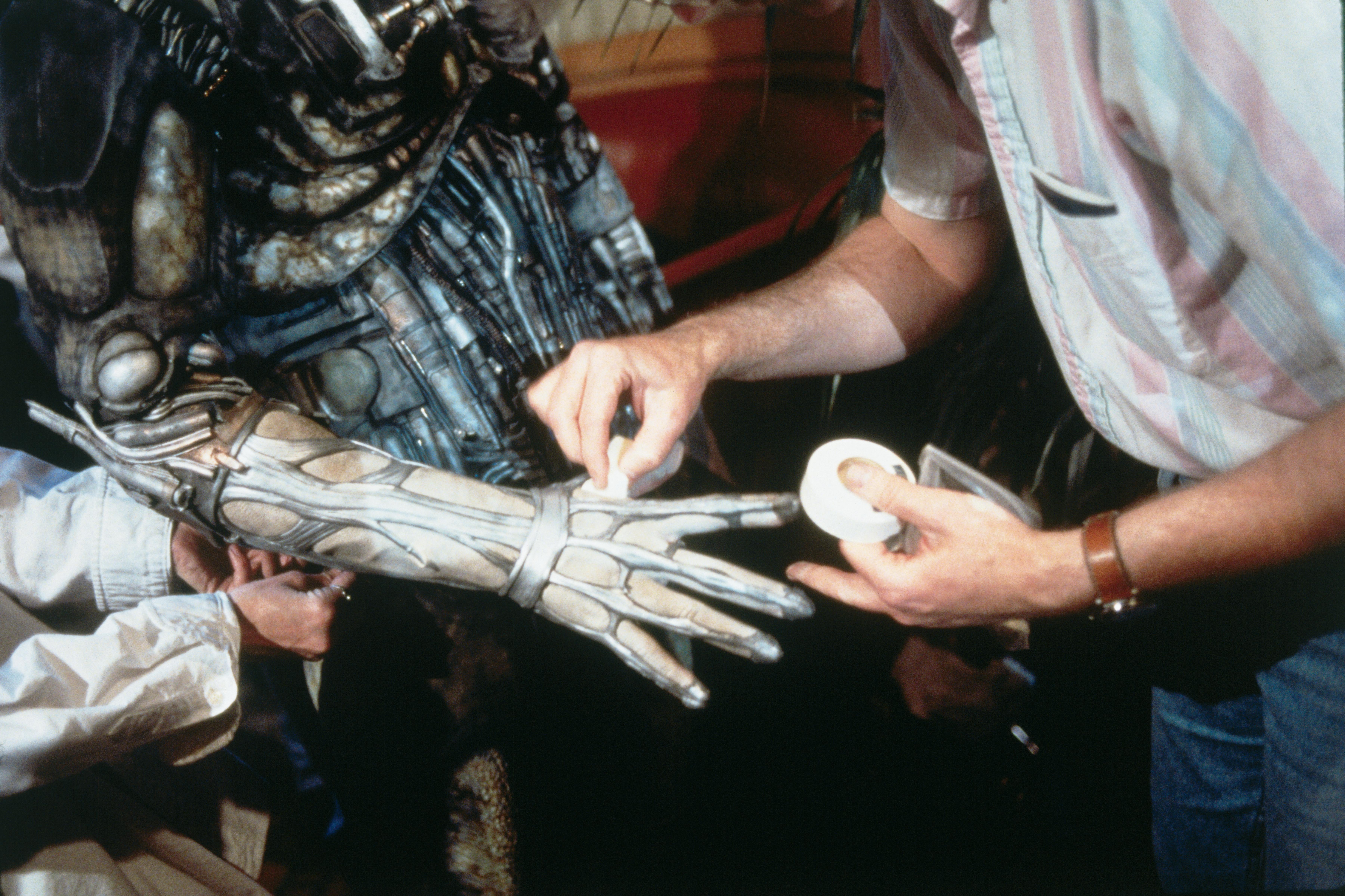Close up of make-up artist touching up Borg hand make-up for Star Trek: First Contact