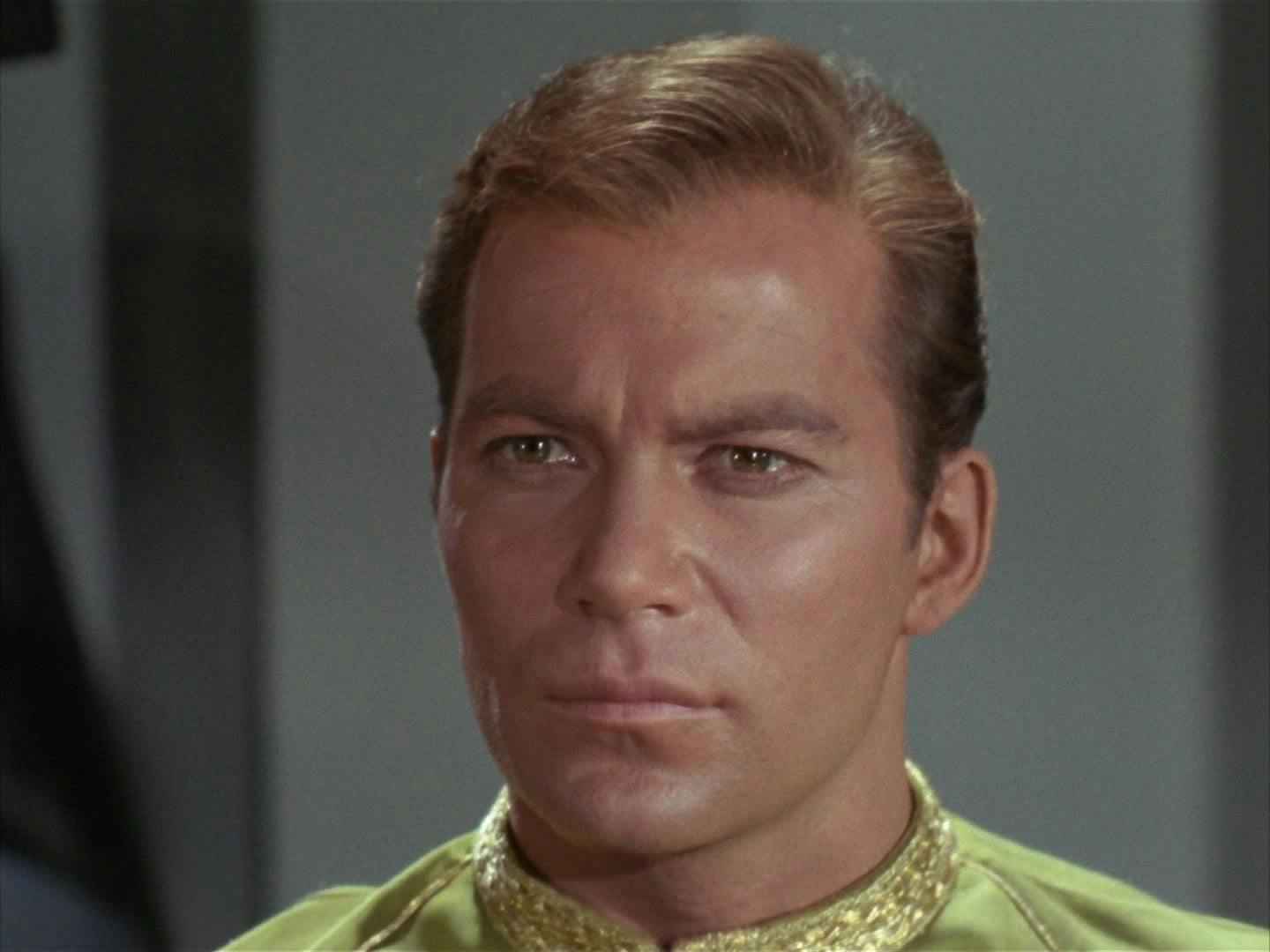 A close up of Captain Kirk in his dress uniform while on trial.
