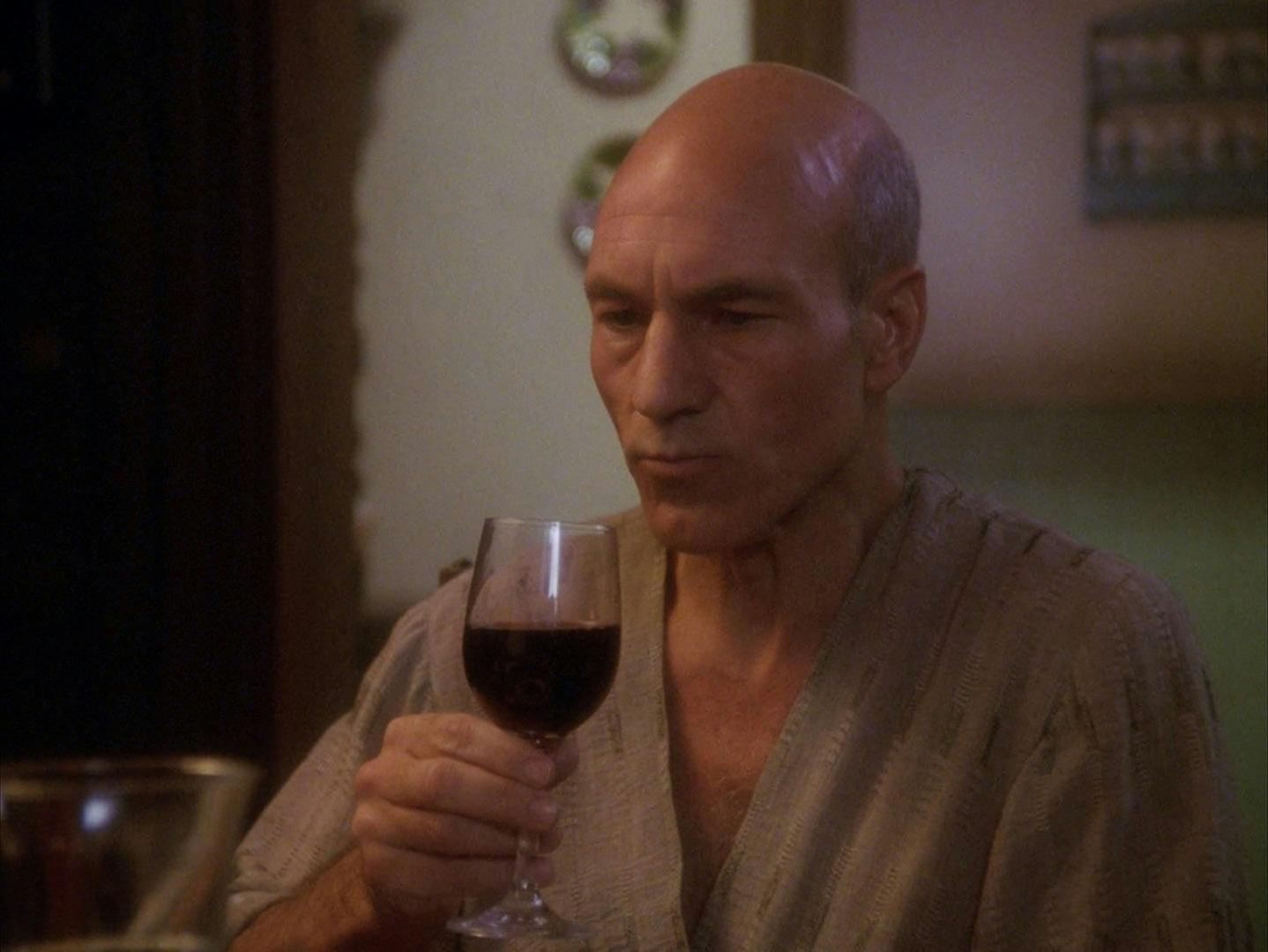 With a sip, Jean-Luc assesses a glass of Chateau Picard wine at the dinner table in 'Family'