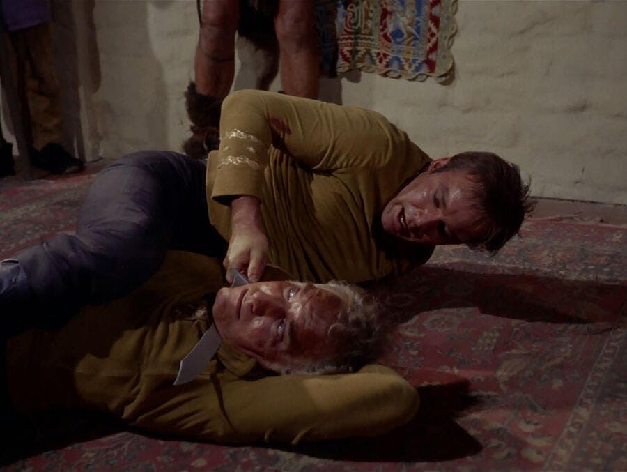 Kirk wrestles and holds a blade up to a throat in 'The Omega Glory'