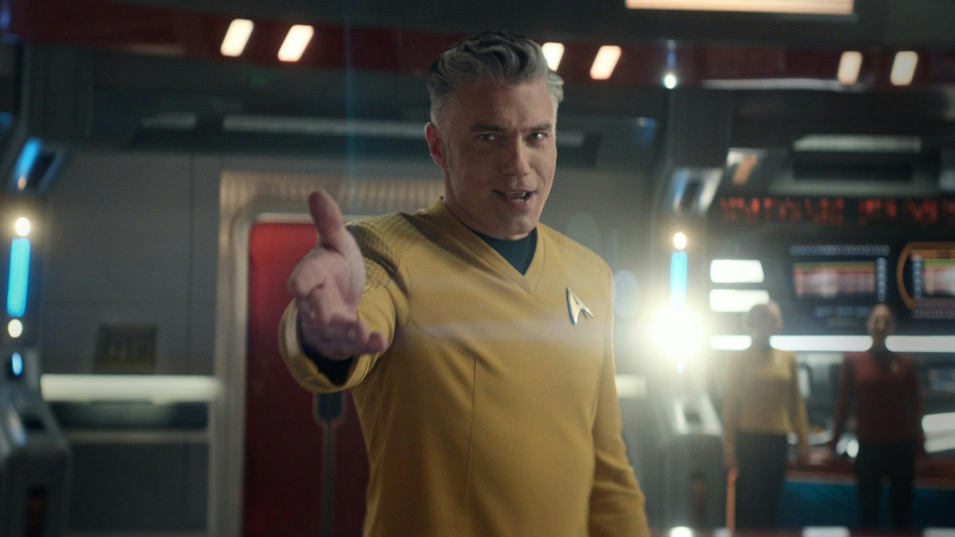 On the Bridge of the Enterprise, Captain Pike extends his right arm out ahead of him in 'Subspace Rhapsody'