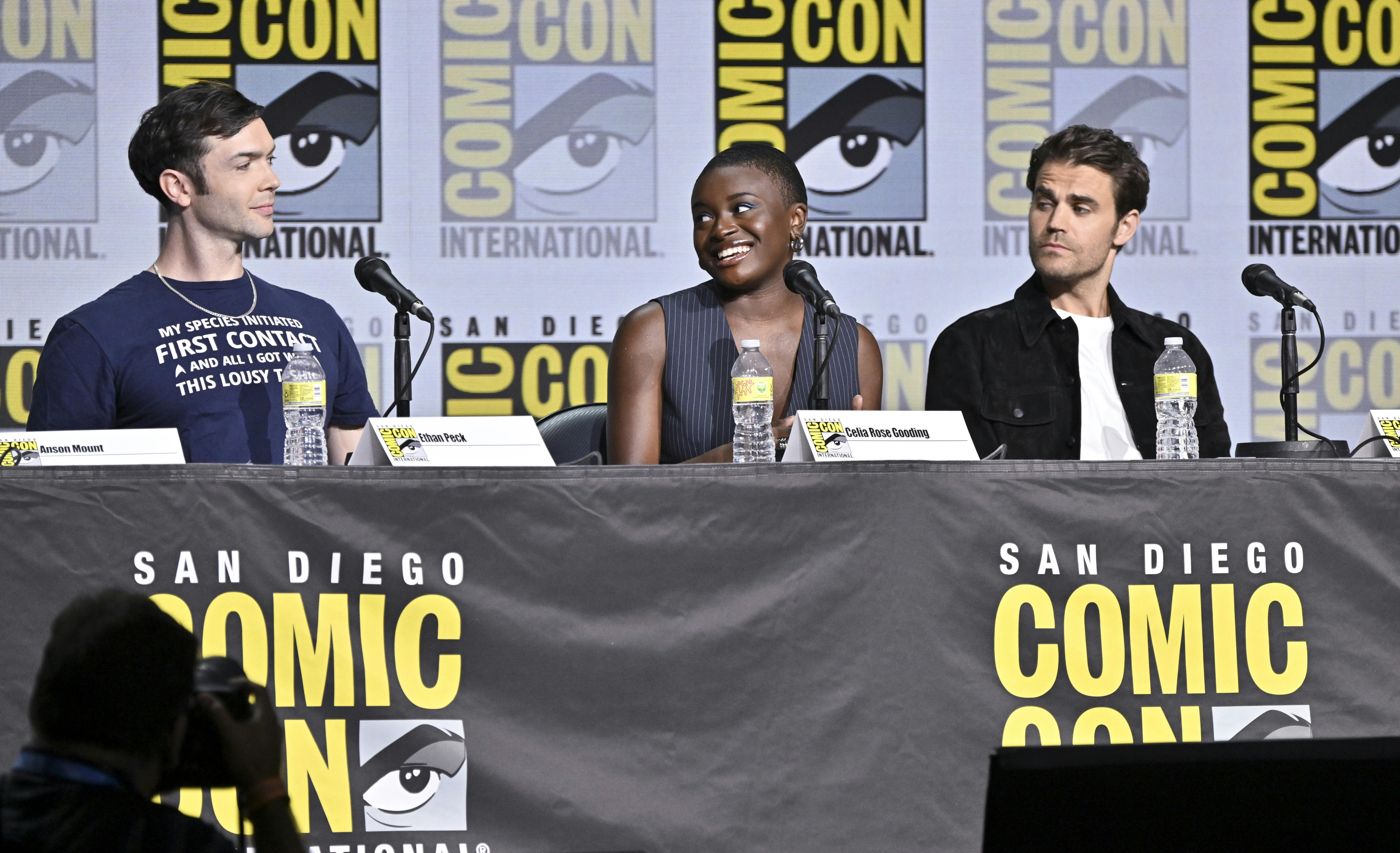 Ethan Peck and Paul Wesley listen to Celia Rose Gooding speak on the Strange New Worlds panel.
