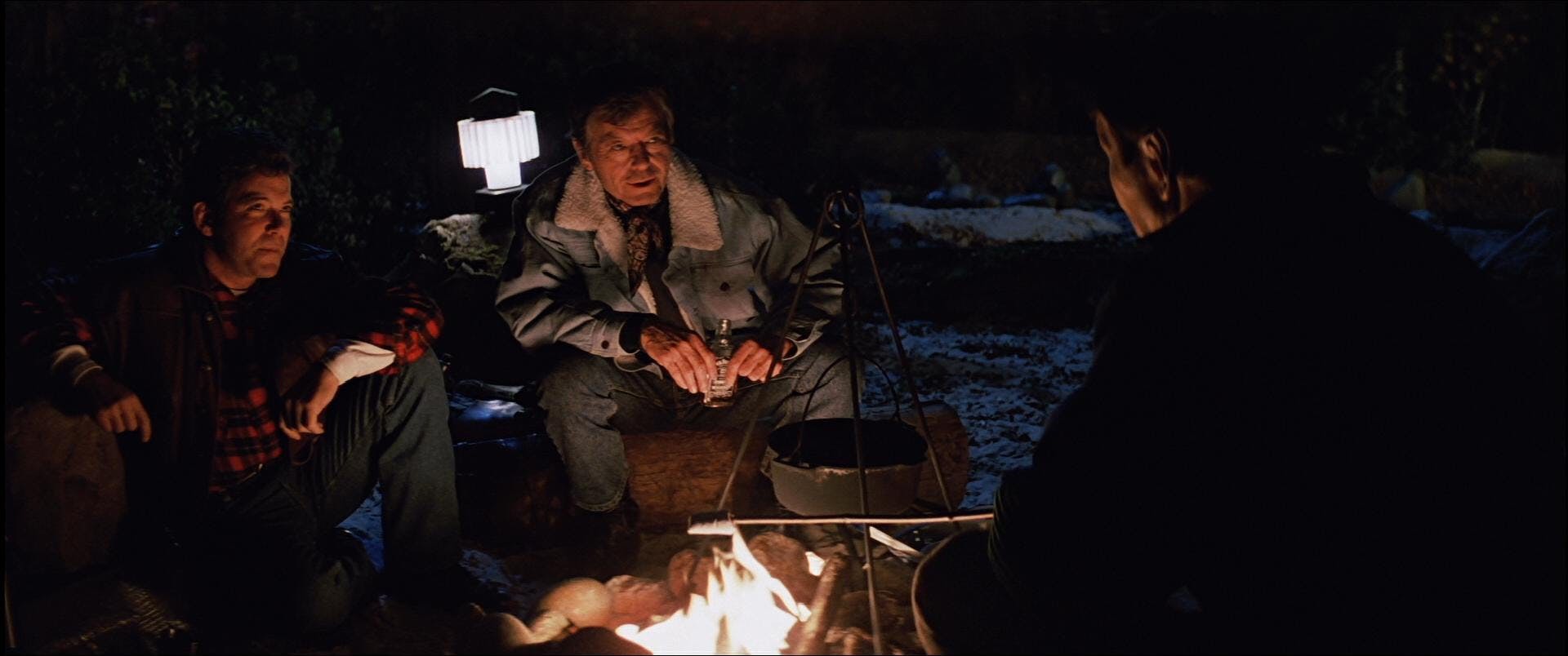 Kirk, McCoy, and Spock sit around a campfire in Star Trek V: The Final Frontier