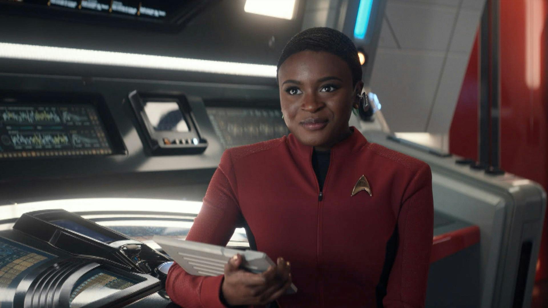 Ensign Uhura looks ahead as she sits at the Comms station on the Enterprise