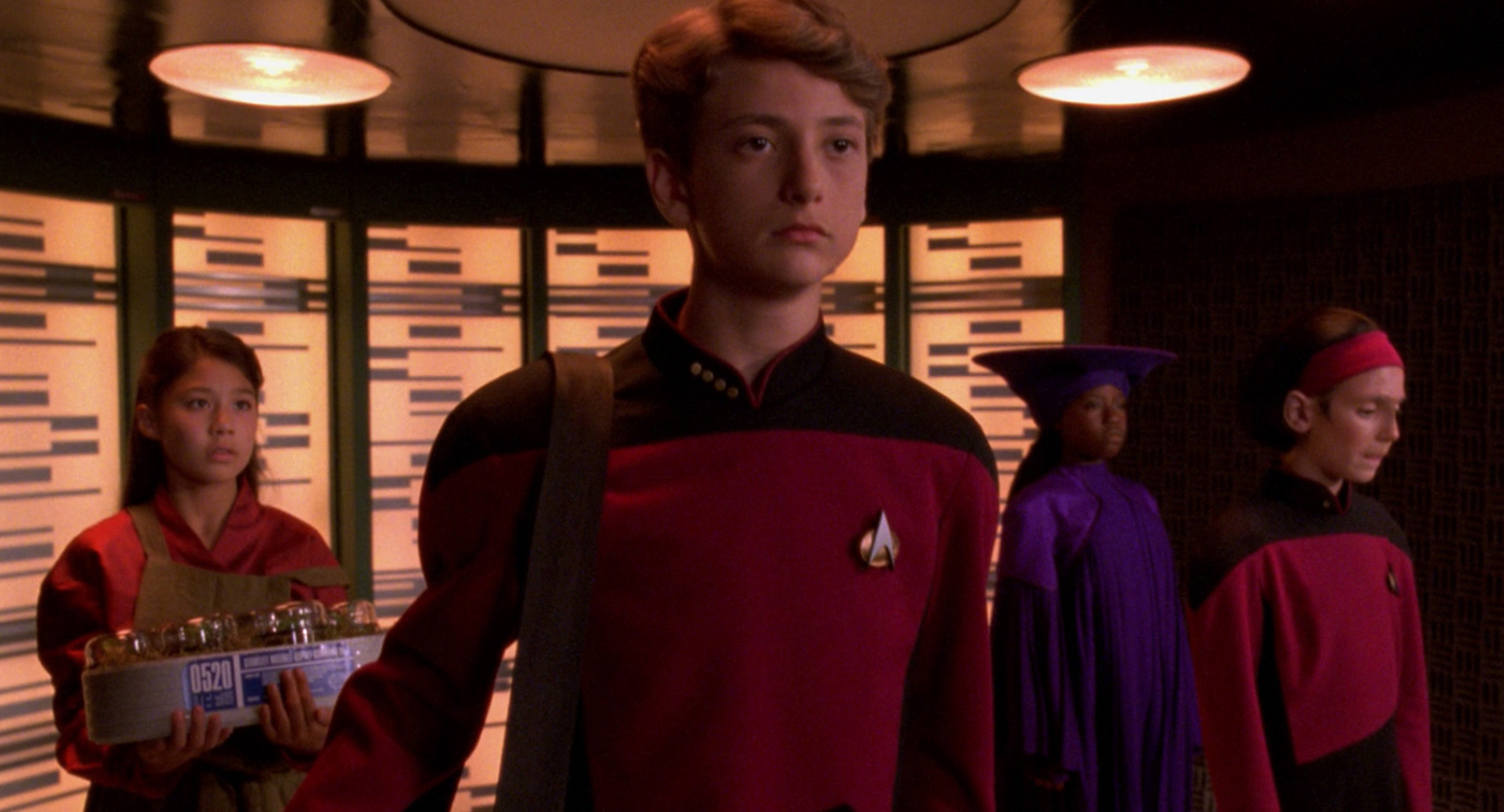 Still from The Next Generation - Rascals - on the transporter, after a malfunction, are kid versions of Keiko, Picard, Guinan, and Ro