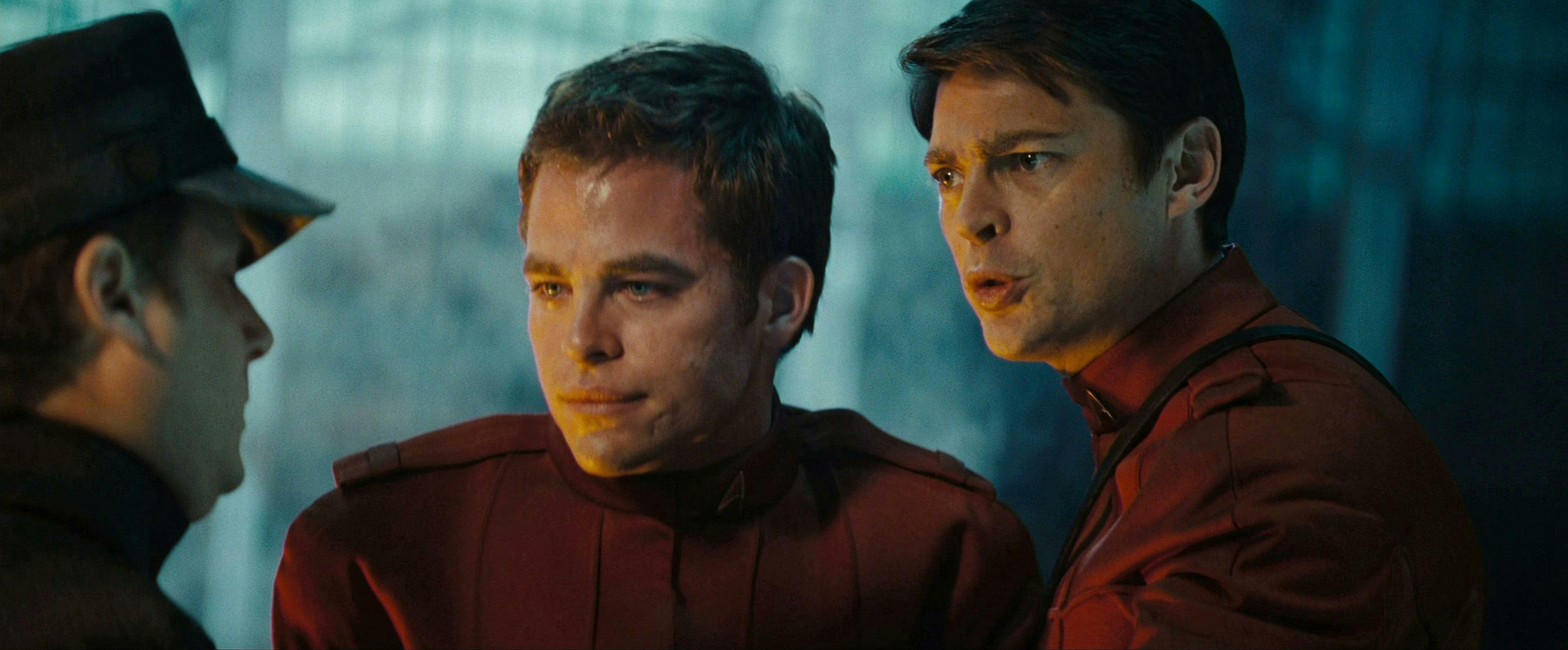 McCoy, holding an ill Kirk up, addresses a Starfleet official in Star Trek (2009)