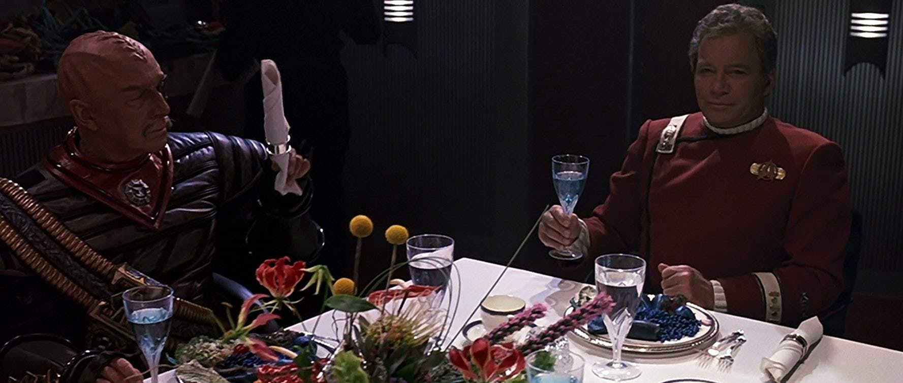 General Chang and James Kirk at the heads of the table in Star Trek VI: The Undiscovered Country