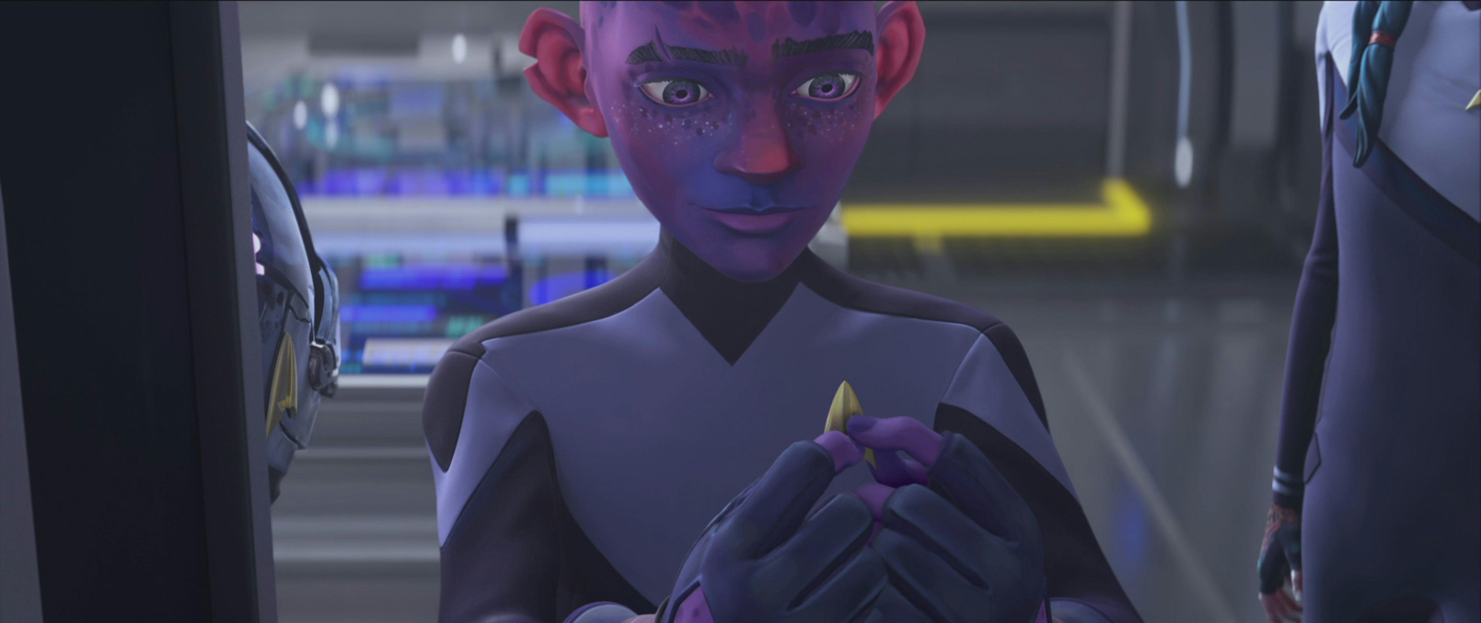 Dal adjusts his combadge on his Starfleet uniform on Star Trek: Prodigy