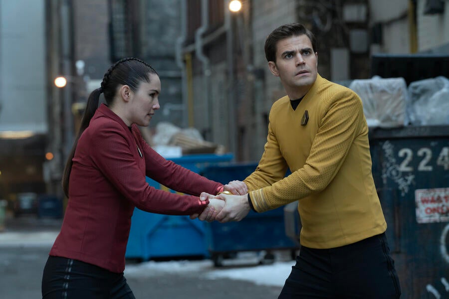 James Kirk and La'An both grip the same device in city alley near graffitied garbage bins in 'Tomorrow and Tomorrow and Tomorrow'