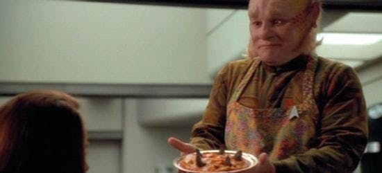 Neelix presents food on a plate on Star Trek: Voyager