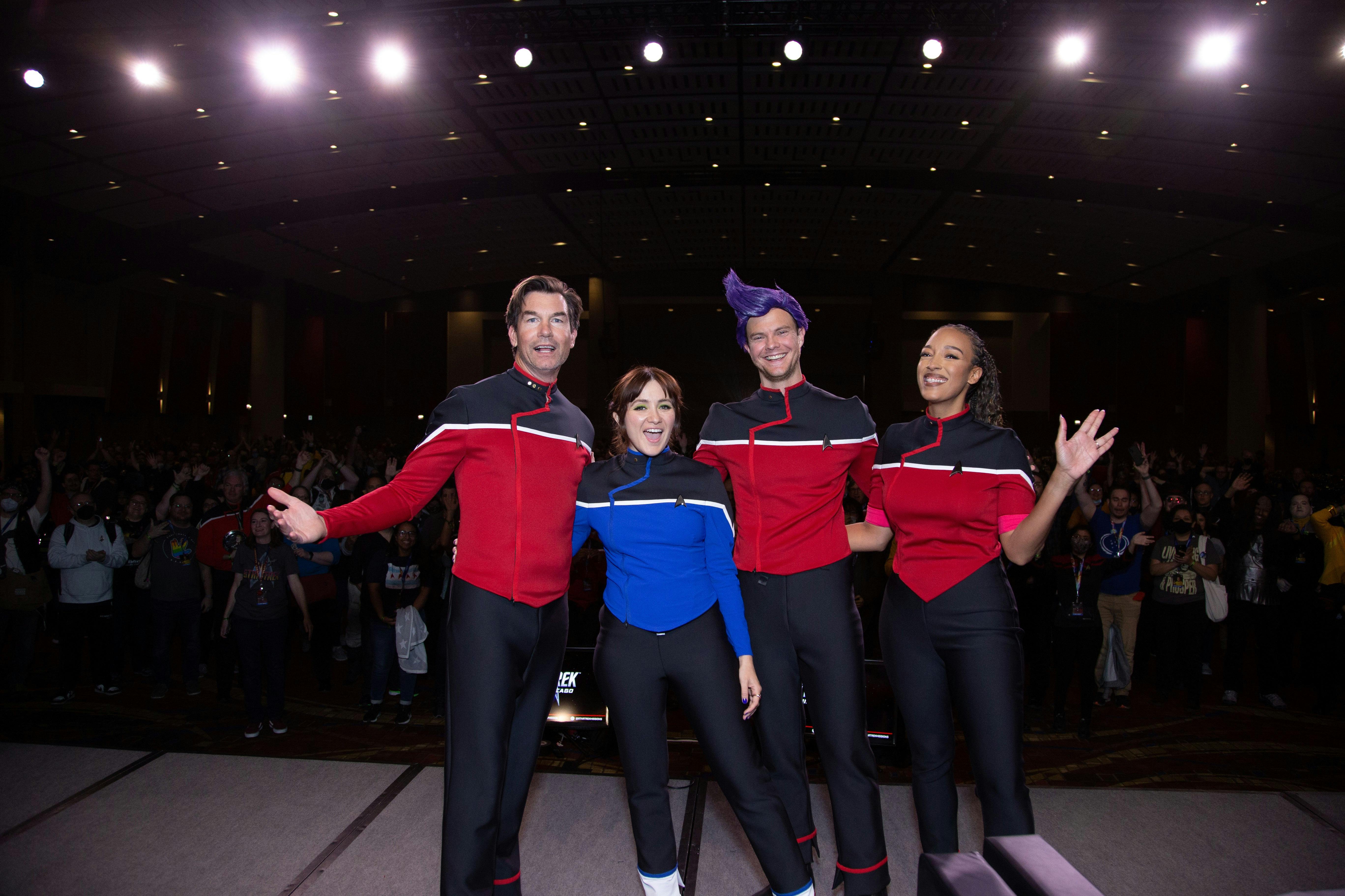 Star Trek: Lower Decks cast Jerry O'Connell, Noël Wells, Jack Quaid, and Tawny Newsome stand in front of a packed audience of Star Trek fans at Star Trek: Mission Chicago 2022