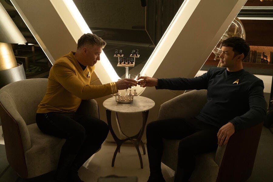 In the captain's quarters, Pike and Spock commiserate and raise their glasses in 'Charades'