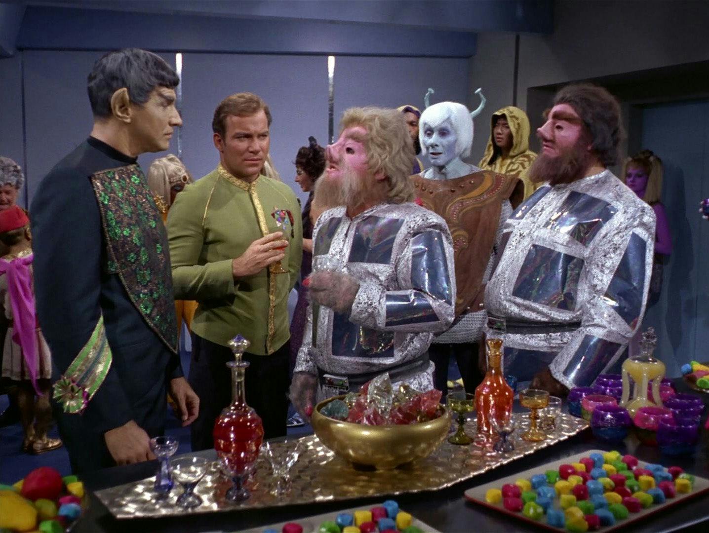 Tellarite ambassador Gav confronts Sarek at a reception for delegates aboard the Enterprise as Kirk monitors the exchange in 'Journey to Babel'