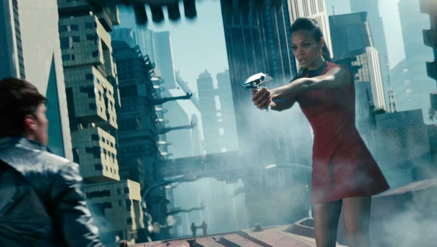 On top of a train, Uhura directs her phaser at Khan in Star Trek Into Darkness