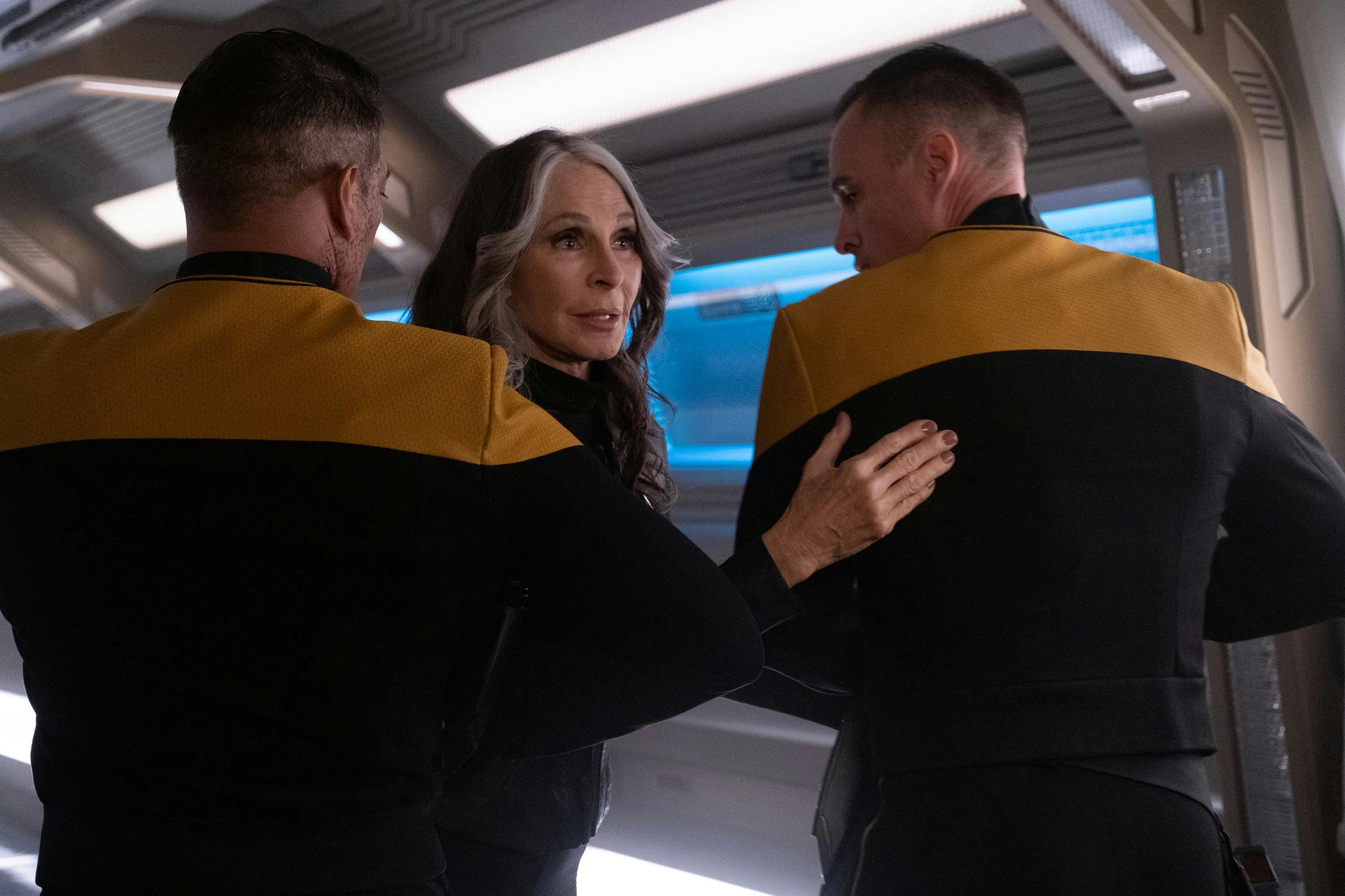 In the Titan corridor, two Starfleet security officials hold back Beverly Crusher in 'Vox'