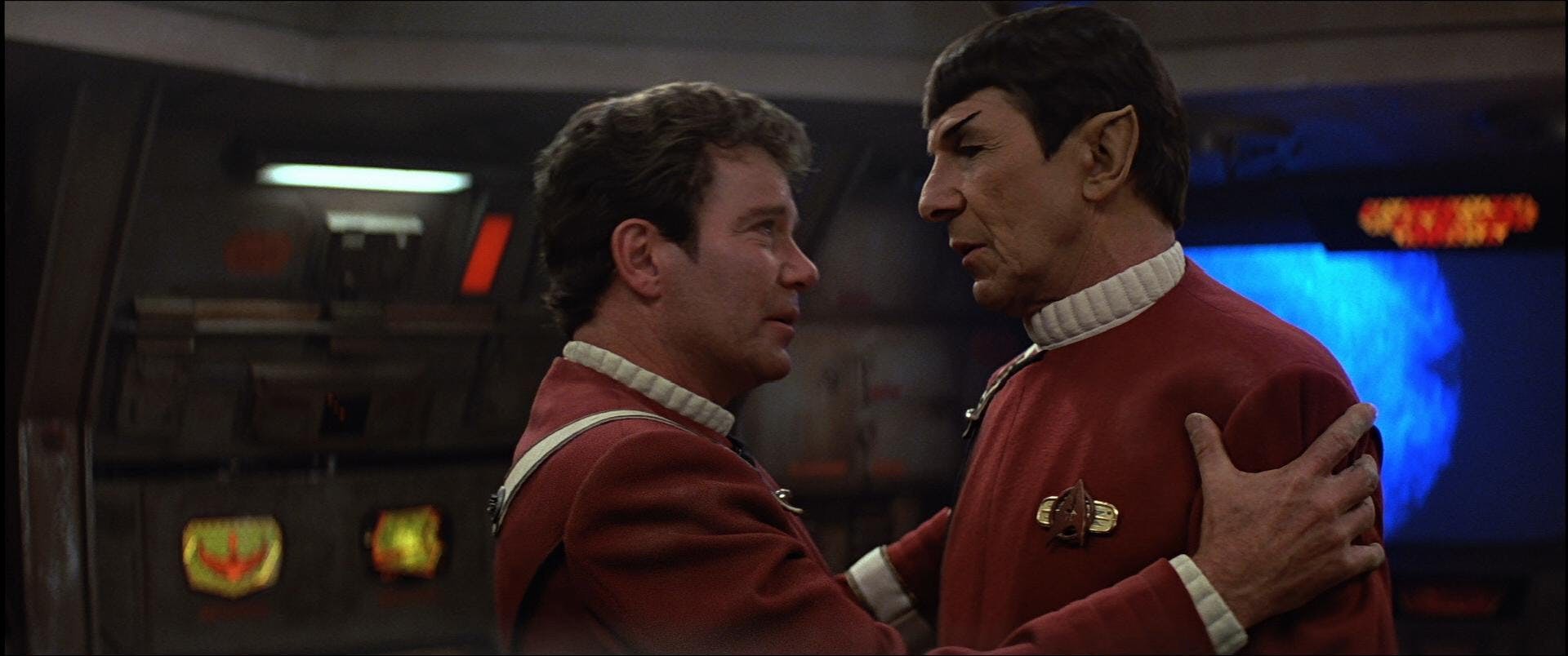 Kirk grips Spock as they stand face to face on the bridge in Star Trek V: The Final Frontier