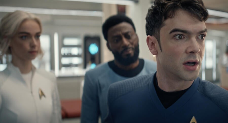 In Sickbay, a human Spock with disheveled hair is shocked at his current state as Chapel and M'Benga stand behind him in 'Charades'