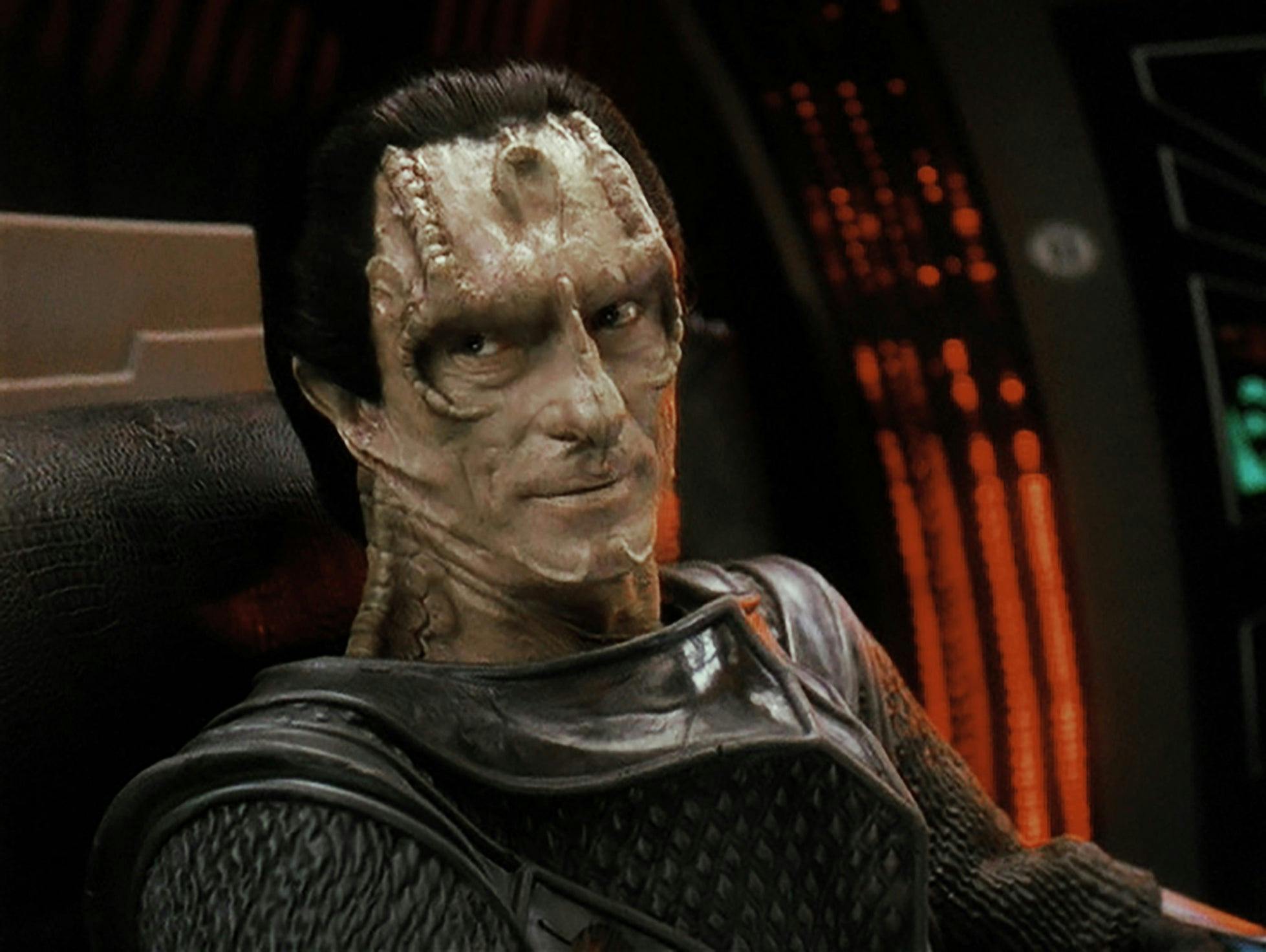 Gul Dukat sits in the captain's chair of his ship.