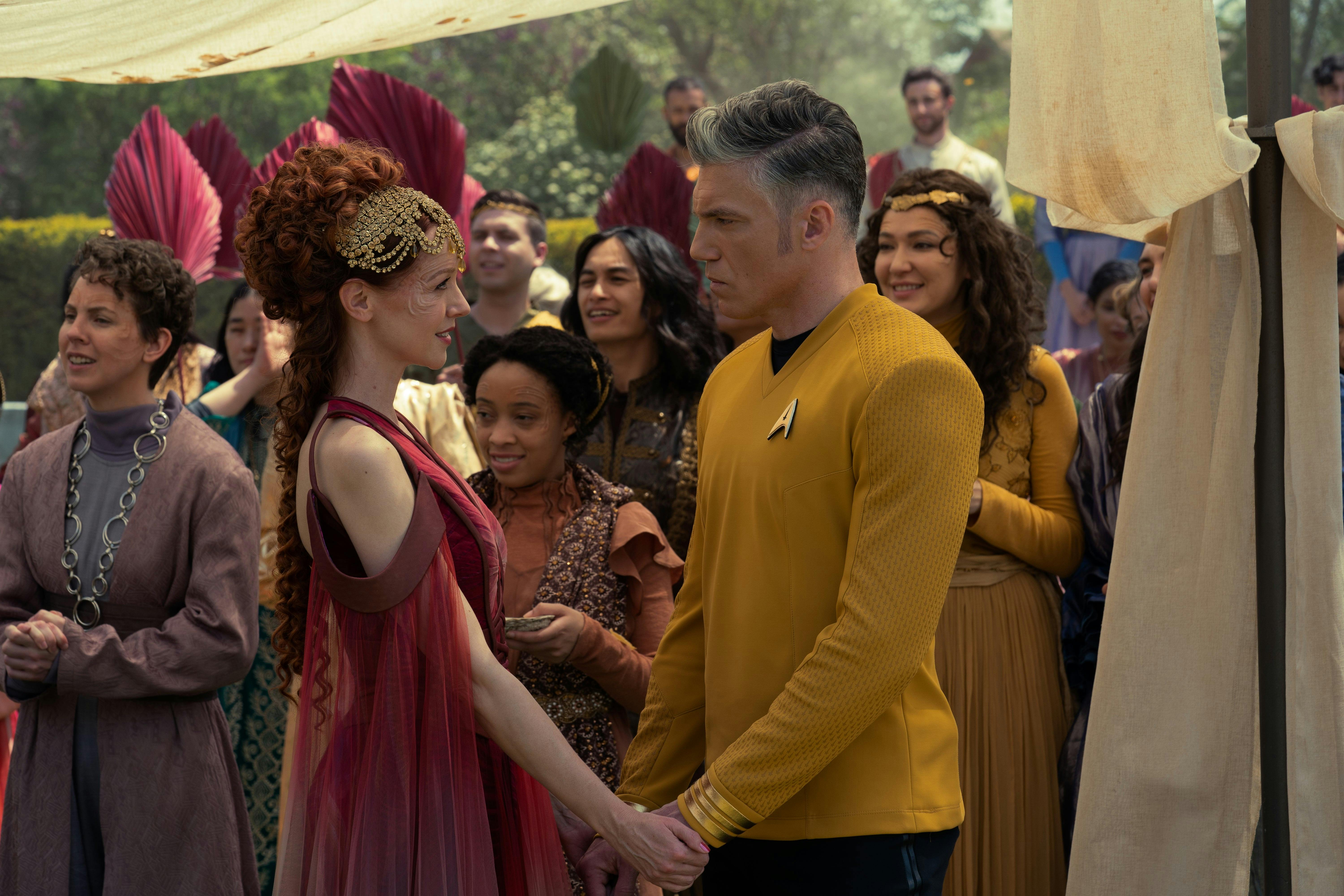 During a celebration in the Majalan system, Alora and Christopher Pike hold each other's hands as they gaze upon one another in 'Lift Us Where Suffering Cannot Reach'