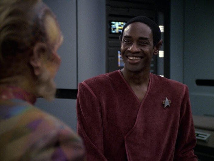 A lighthearted Tuvok grins at Neelix in 'Riddles'