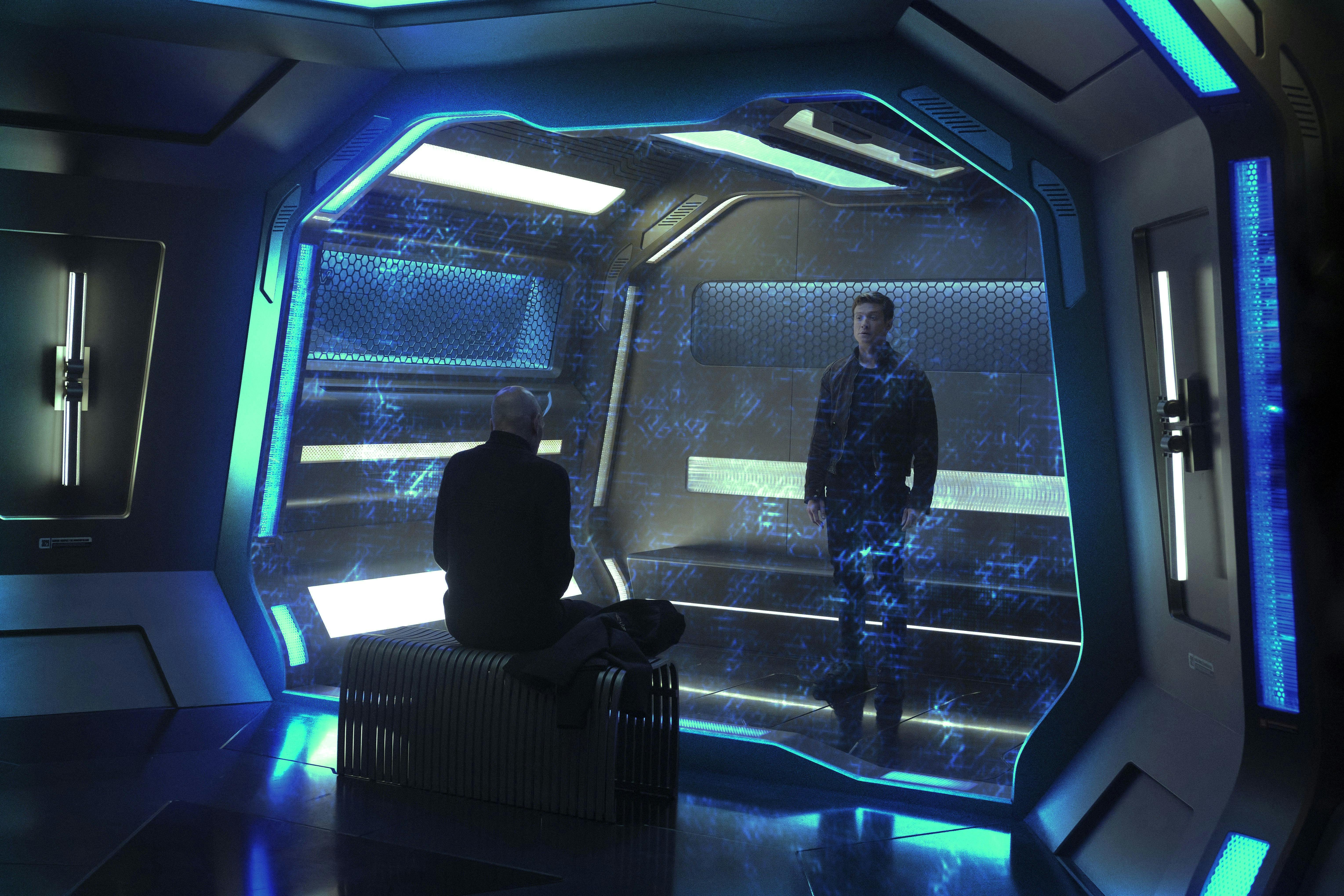 Picard sits across Jack Crusher who stands in the brig of the Titan