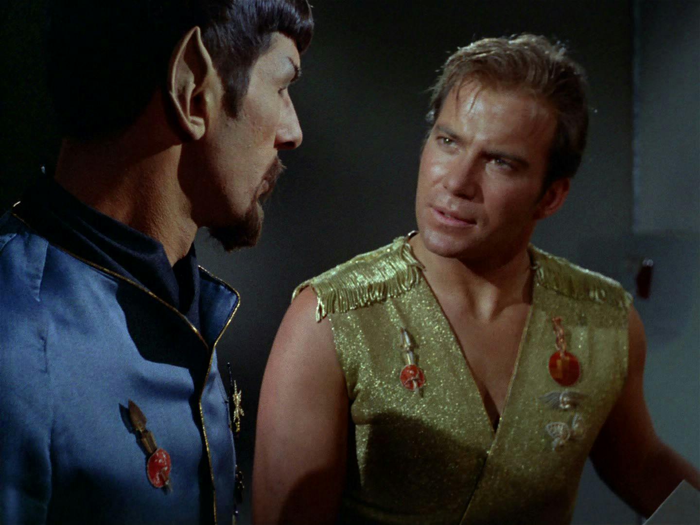 Captain Kirk (The Original Series) addresses Mirror Universe Spock. Both men are in their Mirror Universe uniforms.