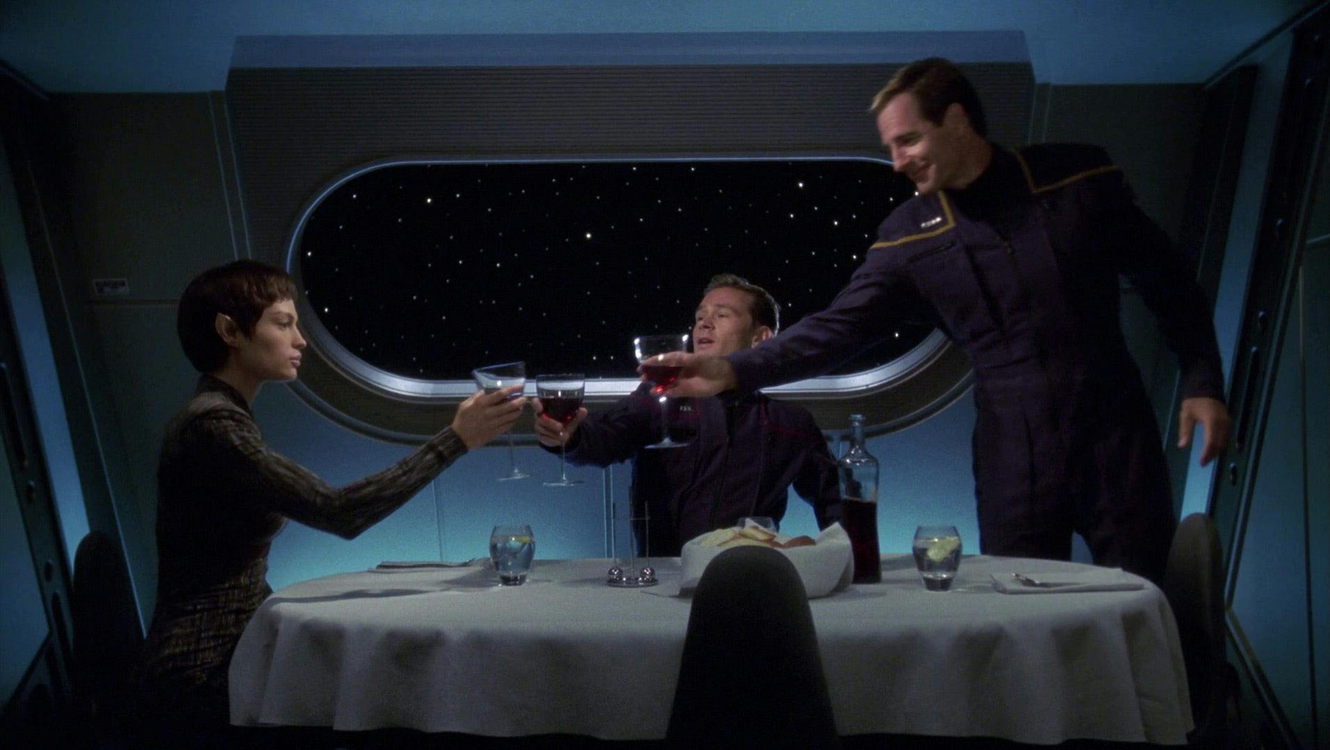 T'Pol raises her glass of wine with Trip and Archer