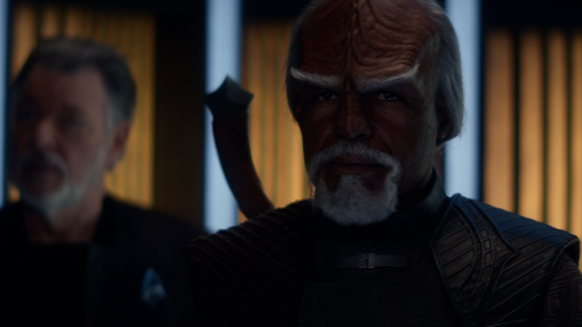 Worf stands on the Titan's transporter with Captain Riker behind him