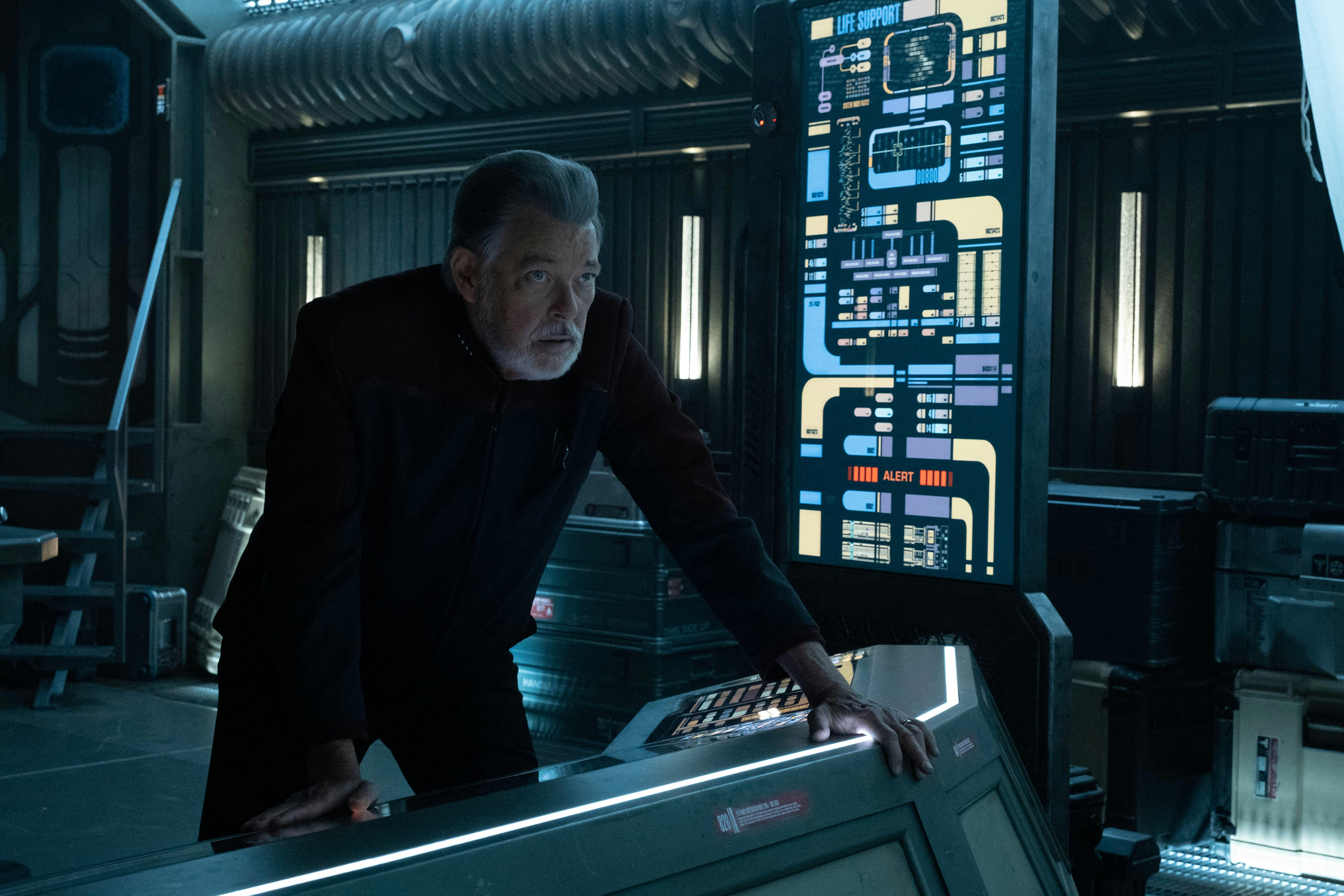 Captain Will Riker looks forward as his hands are on the command screen on Star Trek: Picard
