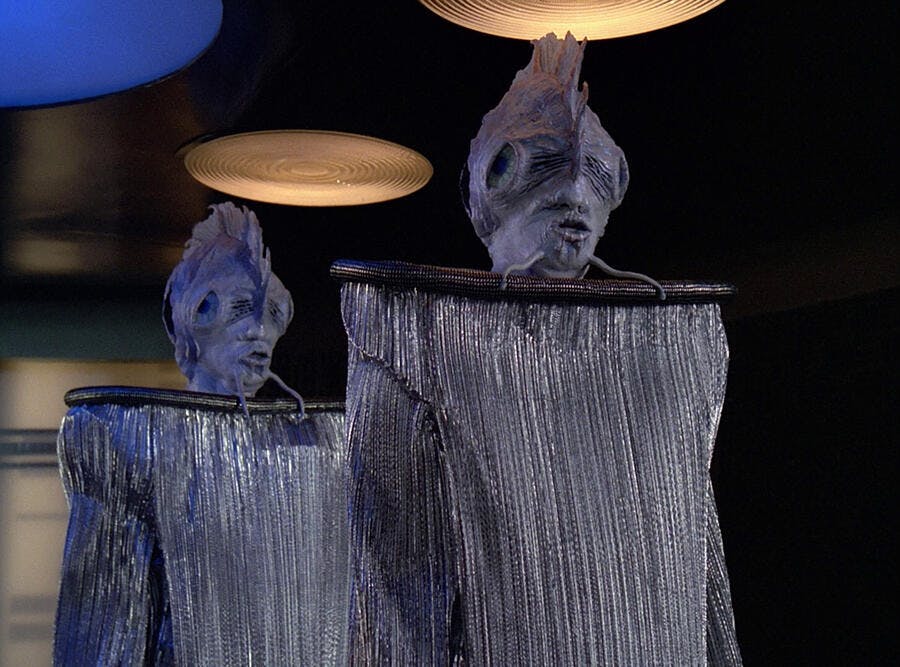 A pair of Antedean delegates on the Enterprise-D transporter pad in 'Manhunt'