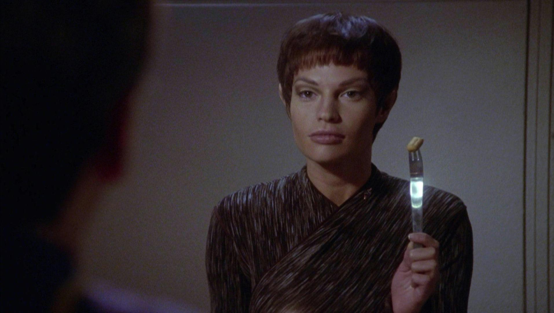 T'Pol eats a breadstick with a knife and fork and proudly raises it up