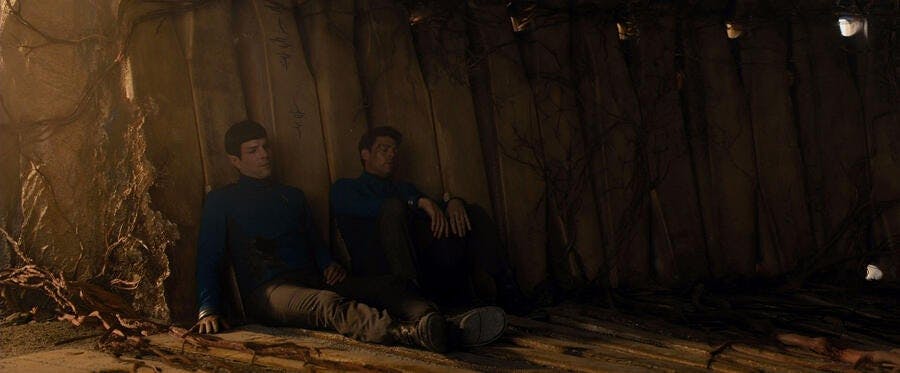 Amid the destruction at Altamid, the weary and injured Spock and Leonard Bones McCoy sit side by side against the wall in Star Trek Beyond
