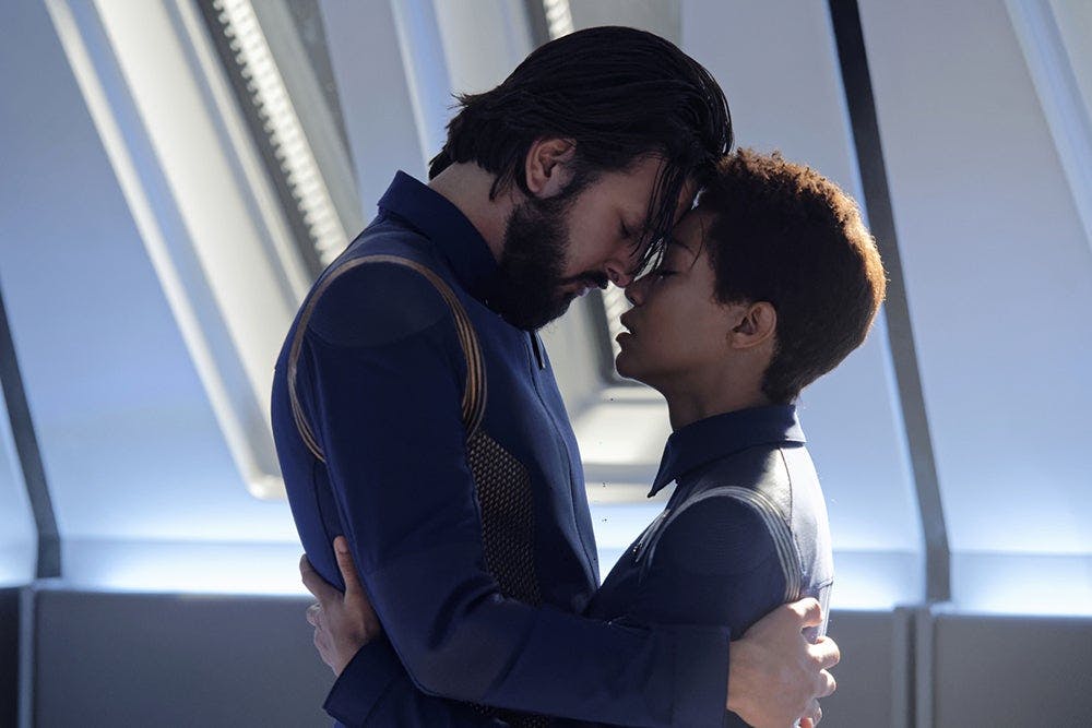 Ash Tyler and Michael Burnham both hold on to each other in an intimate embrace with their foreheads resting on each other in 'The Red Angel'