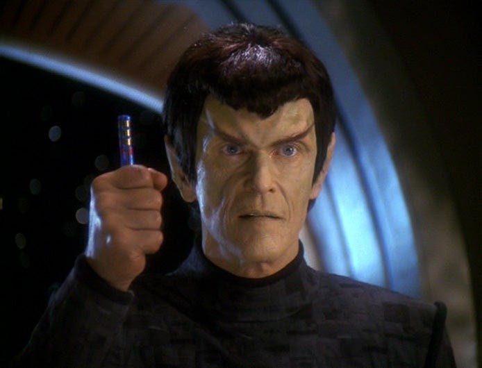 Senator Vreenak lifts his fist as he shouts 'It's a fake' on Star Trek: Deep Space Nine