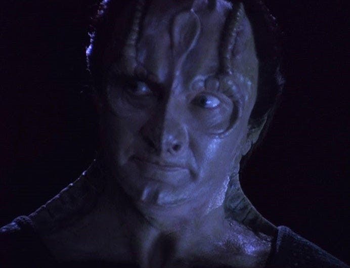 Close-up of Elim Garak as he tilts his head and looks over towards his right in 'Empok Nor'
