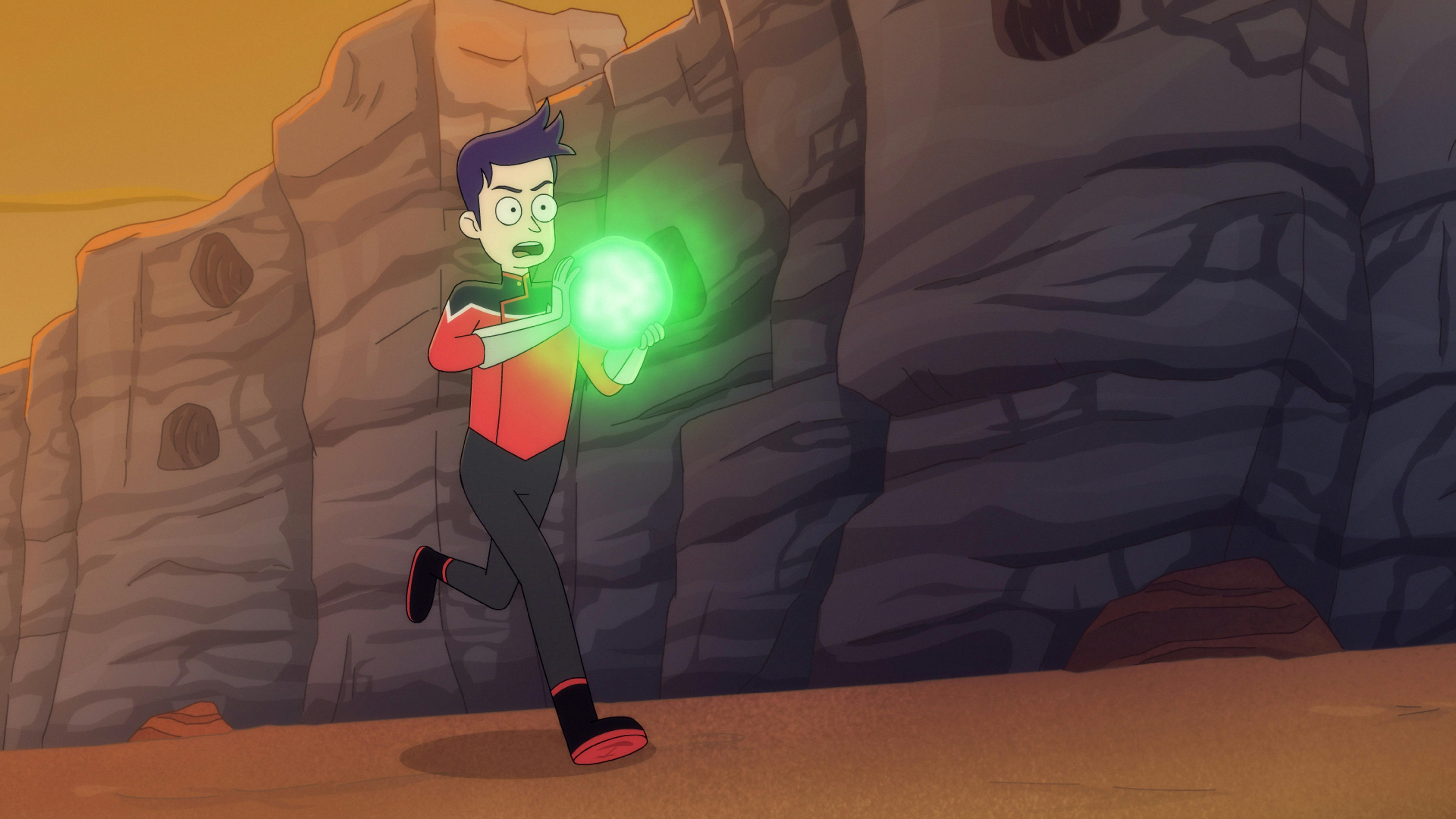 Boimler runs while carrying a glowing green orb in 'Mining The Mind's Mines'
