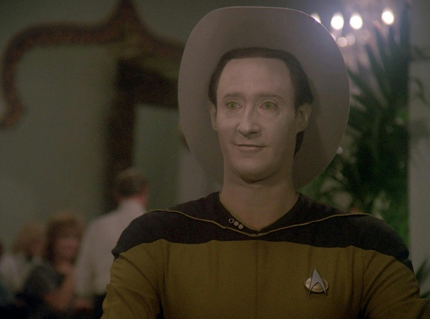 Data looks excited after winning blackjack, all while wearing a cowboy hat.