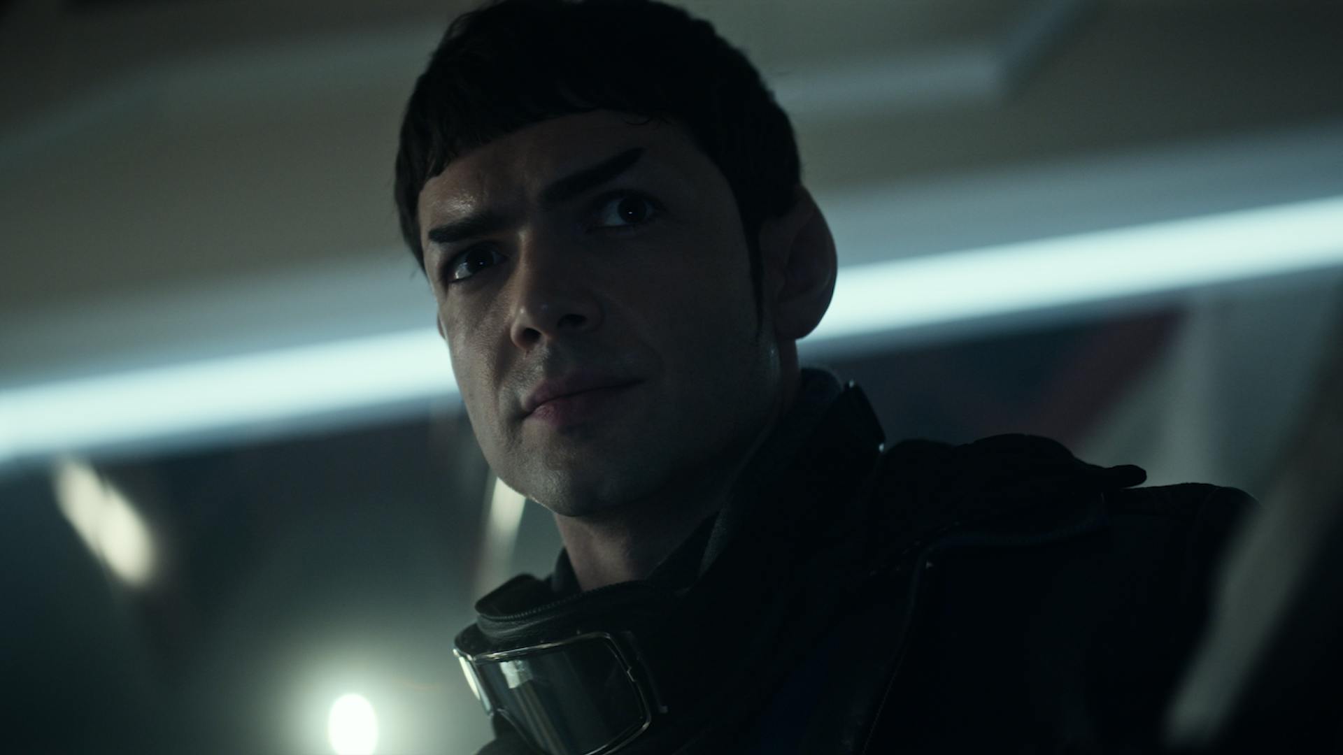 Spock (Ethan Peck) stands in close up in a darkened hallway.