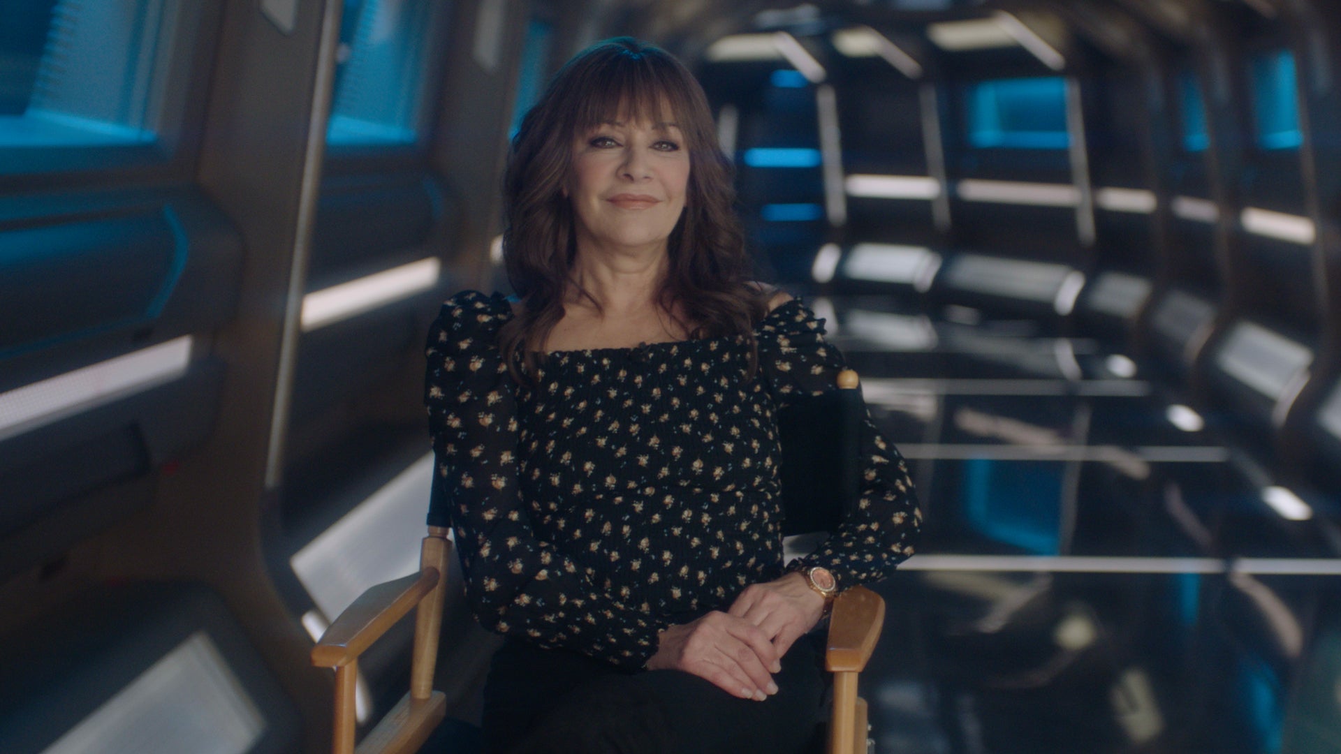 Marina Sirtis sits in the Titan corridor in a segment for The Ready Room