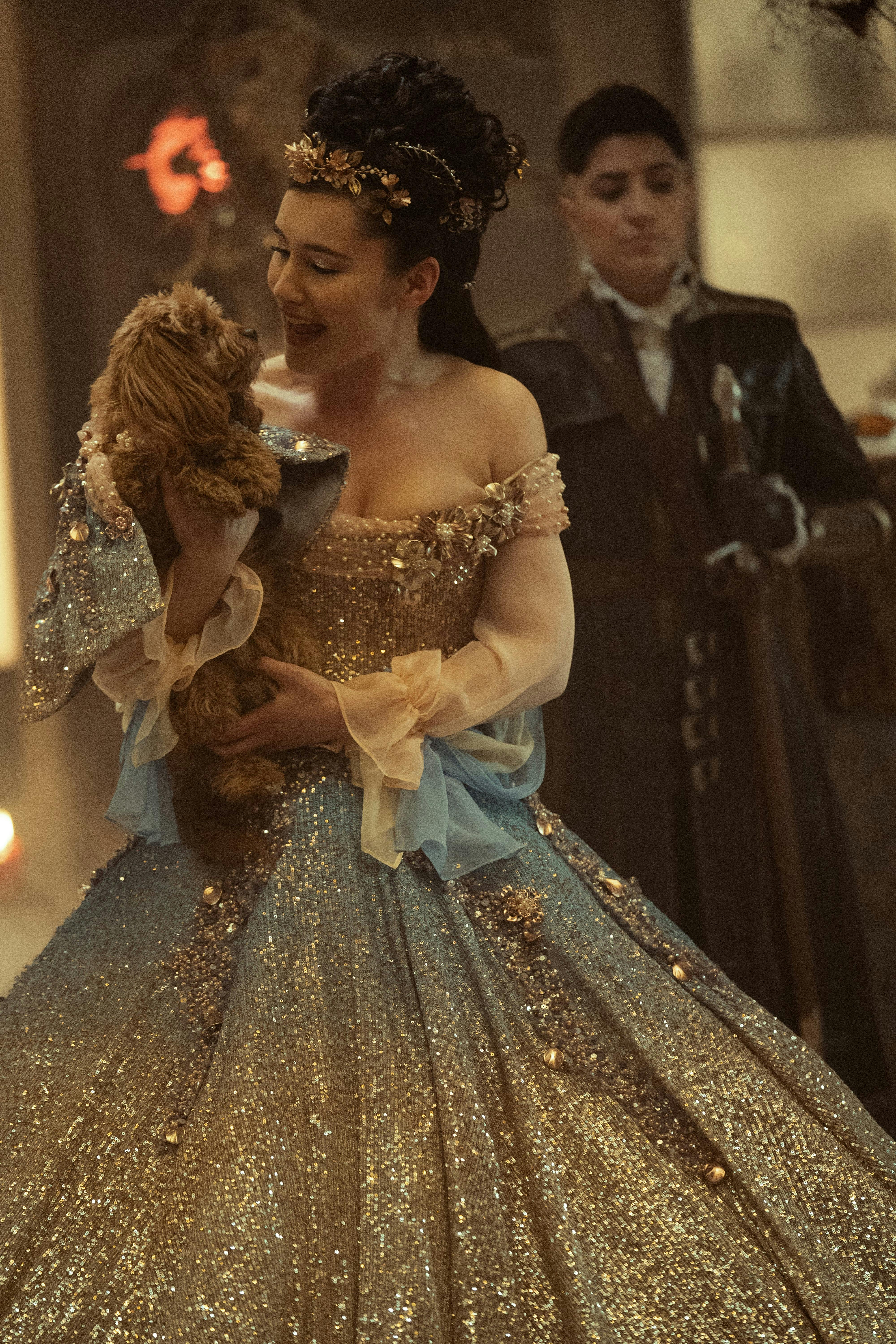 La'An Noonien Singh (Christina Chong) cuddles a puppy while wearing a princess dress.