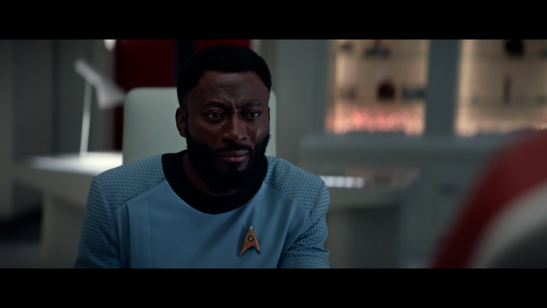 Dr. M'Benga sitting and listening - Strange New Worlds