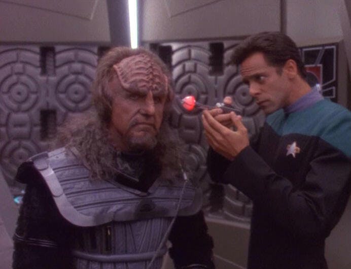 Julian Bashir studies Odo who he recently surgically transitioned into a Klingon in 'Apocalypse Rising'