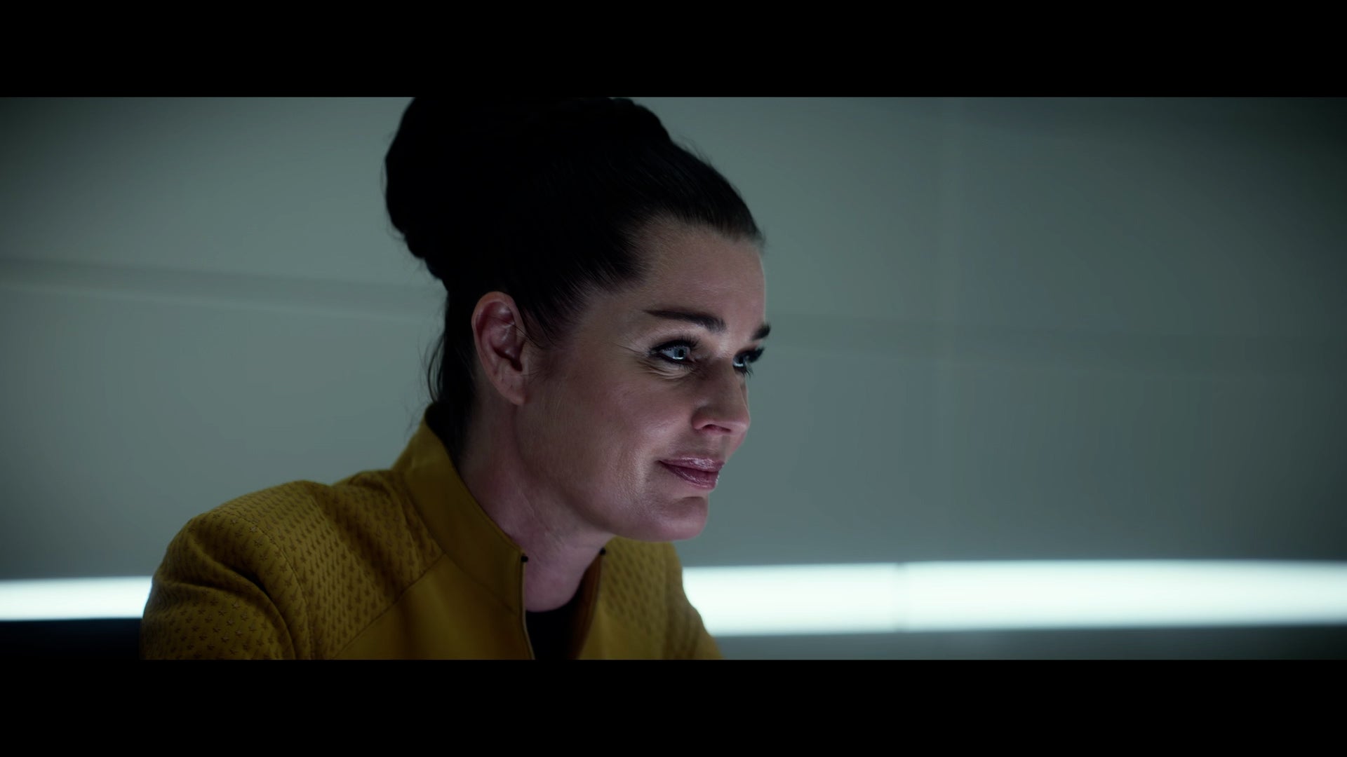 Side view of Una, sitting, looking directly ahead. 