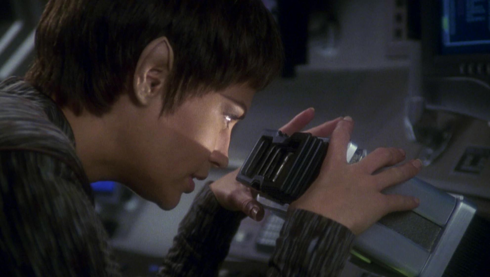 T'Pol looks into a scope