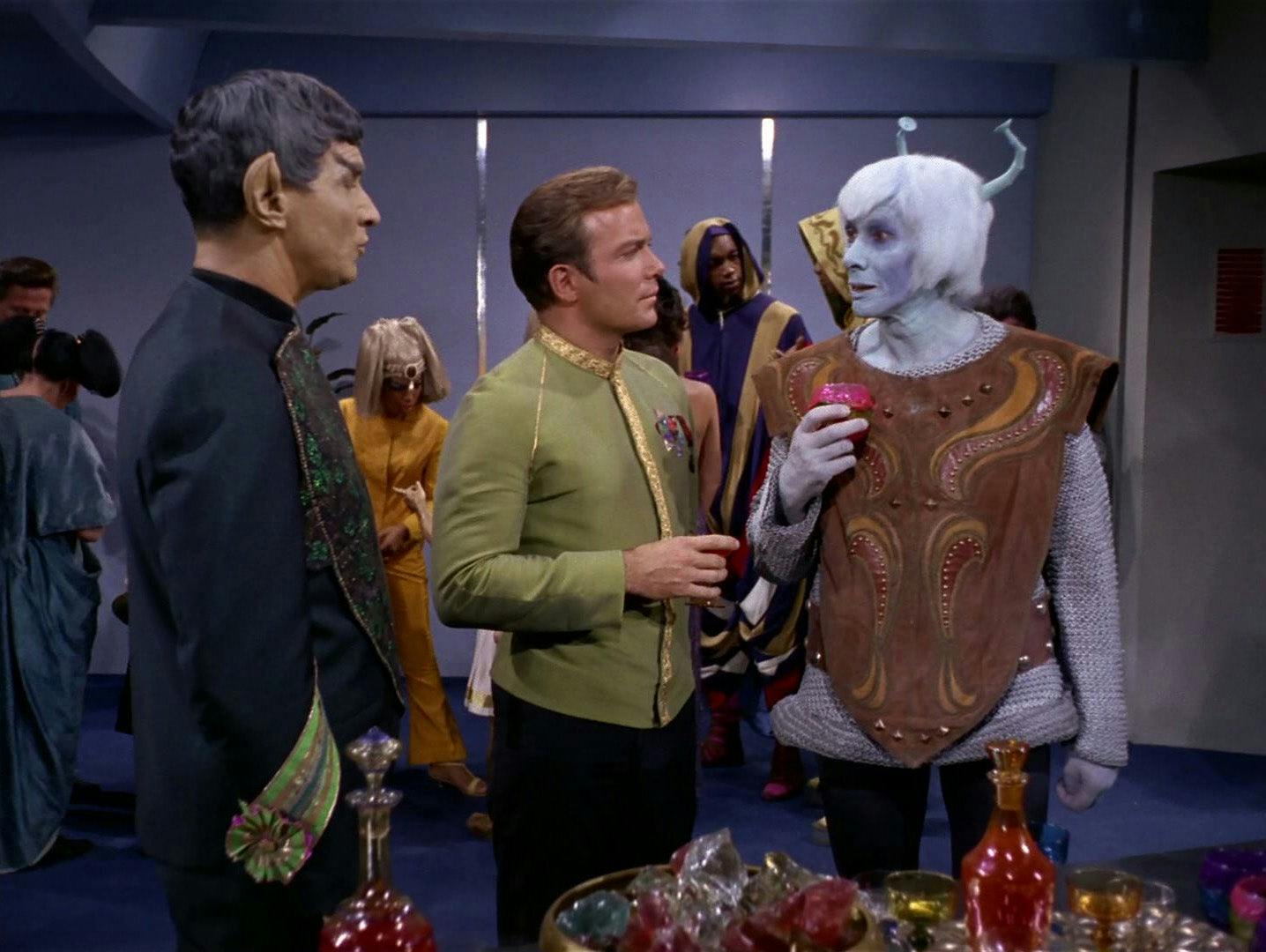 Sarek and Kirk are engaged in conversation with an Aenar delegate at a reception aboard the Enterprise in 'Journey to Babel'