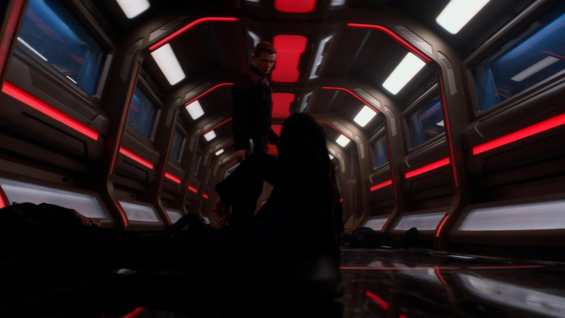 Jack Crusher surrounded by downed Starfleet officers in the Titan corridor in Star Trek: Picard