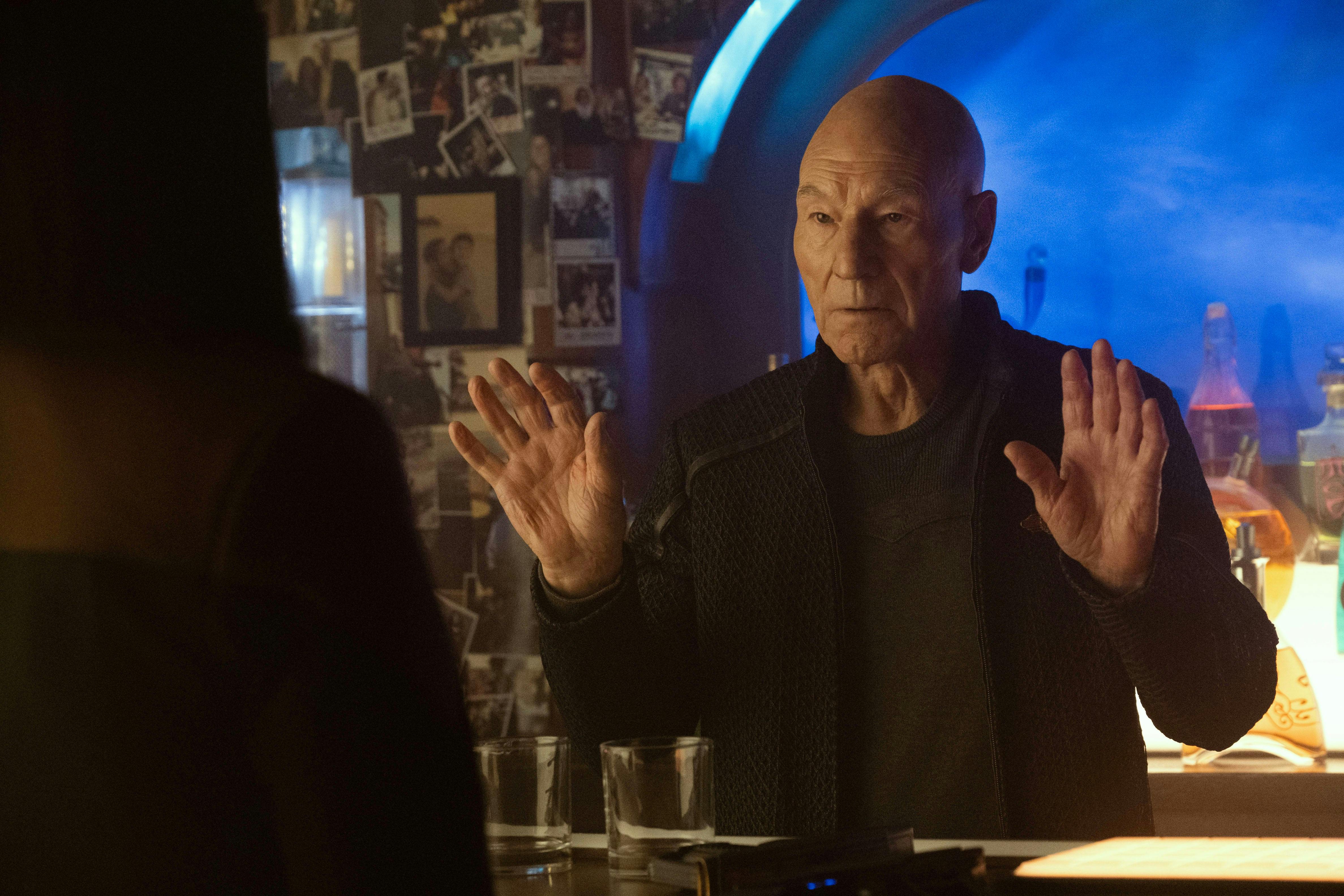 In the 10 Forward holoprogram, Picard stands with his hands up in defense in front of a figure
