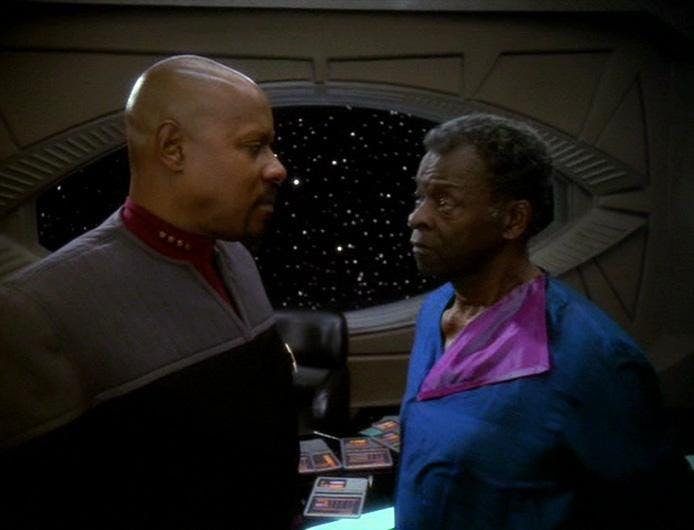 In his office, Captain Sisko stands face to face with his father Joseph Sisko on Star Trek: Deep Space Nine